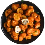 Crunchy battered mushrooms served with dipping sauce, a savory appetizer.