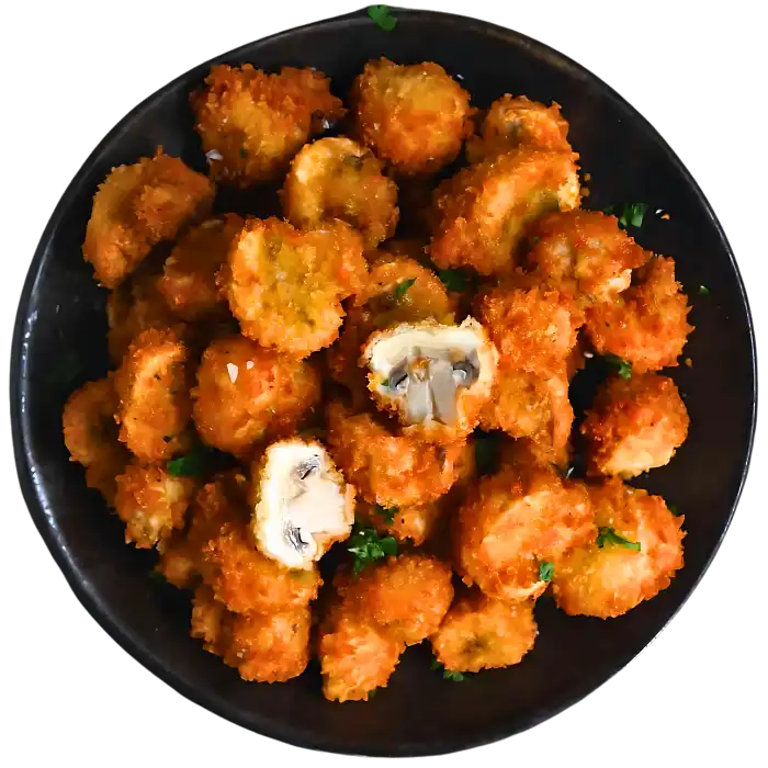 Crunchy battered mushrooms served with dipping sauce, a savory appetizer.